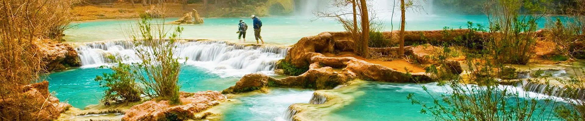 Couple walking in the waters at Grand Canyon Havasu Falls